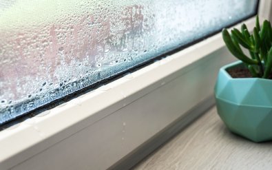 The accumulation of condensation on the edge of a window.